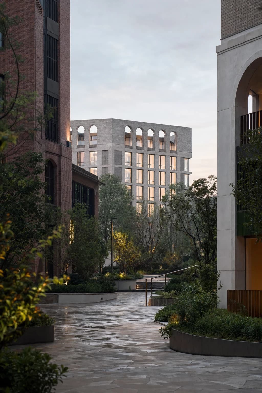 A newly completed mixed-use urban quarter with brick, pale stone and mature planting